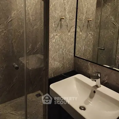 Elegant modern bathroom with marble walls and sleek fixtures