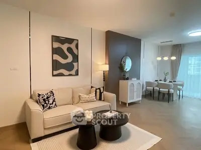 Modern living room with stylish decor and dining area, featuring elegant furniture and ambient lighting.