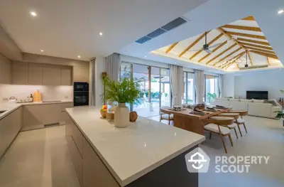 Luxurious open-plan kitchen and living area with modern design and ample natural light.