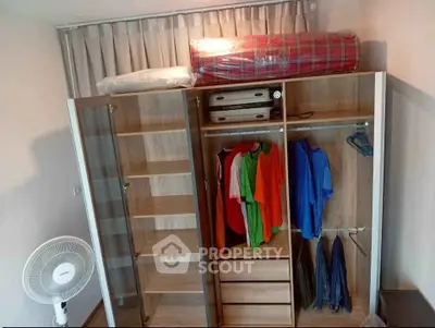 Spacious wardrobe with organized clothing and storage in modern bedroom