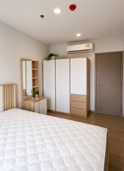 Modern bedroom with minimalist furniture and air conditioning in a stylish apartment.