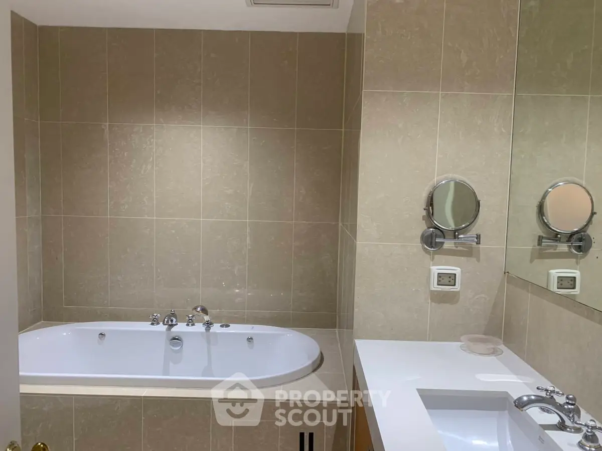 Luxurious bathroom with elegant bathtub and modern fixtures in a stylish real estate property.