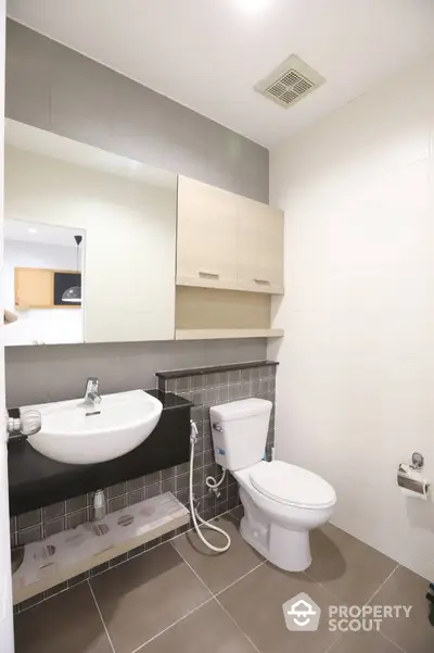 Modern bathroom with sleek fixtures and neutral tiles