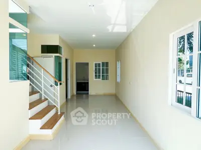 Spacious modern hallway with sleek staircase and large windows
