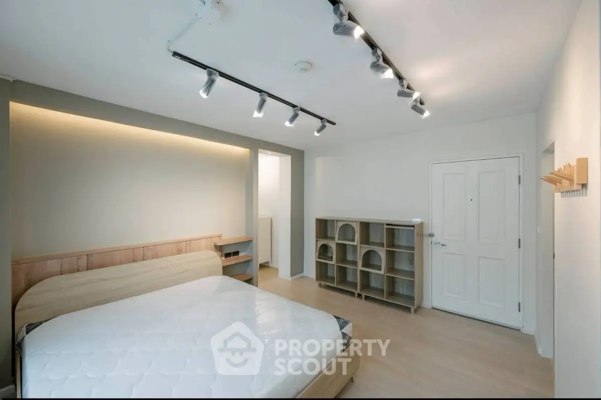 Modern bedroom with stylish lighting and wooden furniture