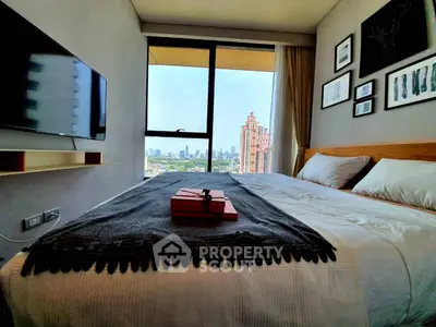 Modern bedroom with city view, stylish decor, and wall-mounted TV in a high-rise apartment.