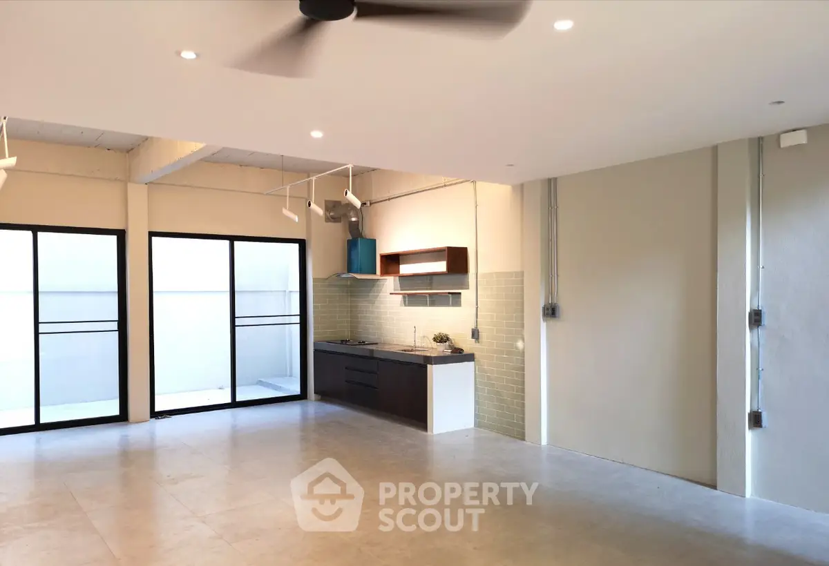 Spacious modern living room with open kitchen and large windows