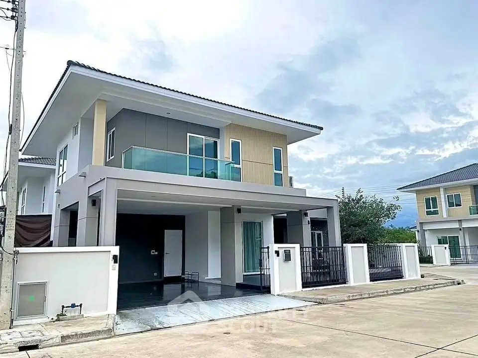 Modern two-story house with spacious balcony and sleek exterior design in a suburban neighborhood.