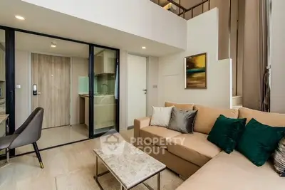 Modern living room with stylish decor and open kitchen layout in a contemporary apartment.