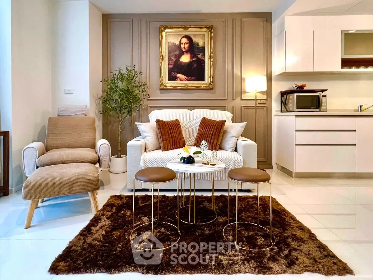 Chic living room with modern furniture and elegant decor, featuring a cozy sofa and stylish armchair.