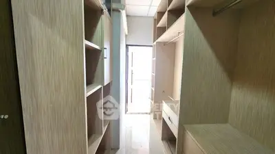 Spacious walk-in closet with ample shelving and natural light