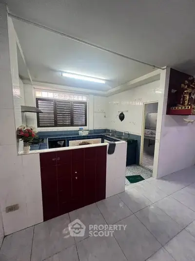Spacious kitchen with open layout and modern appliances in a well-lit home.
