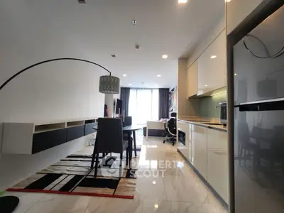 Modern open-plan living and dining area with sleek kitchen and stylish decor.