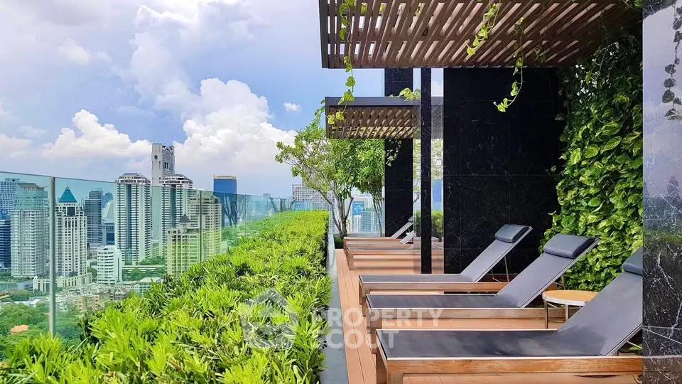 Luxurious rooftop garden with stunning city skyline view and modern lounge chairs.