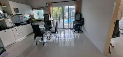 Spacious kitchen with modern appliances and pool view, perfect for family gatherings.