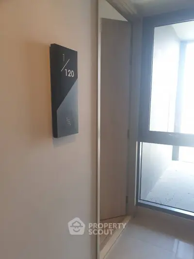 Modern apartment entrance with sleek door and room number signage