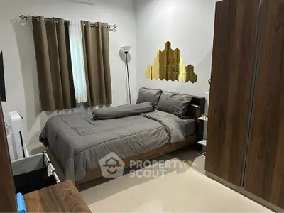 Cozy bedroom with modern decor and wooden furniture, perfect for relaxation.