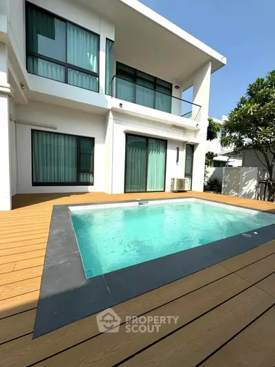 Modern villa with private pool and elegant deck in sunny setting