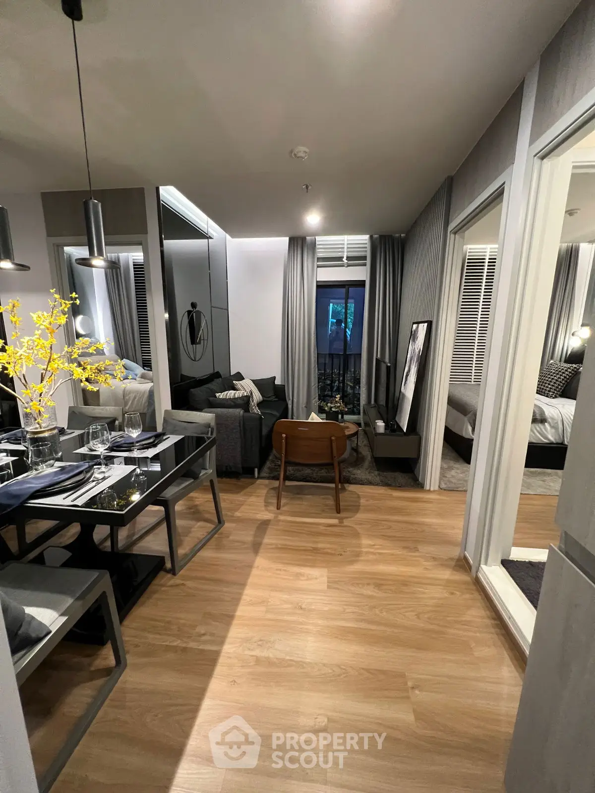 Modern open-plan living and dining area with stylish decor and wooden flooring.