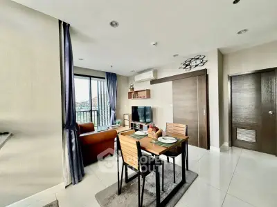 Modern living room with dining area and balcony view in stylish apartment