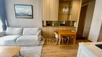 Modern living room with cozy sofa, wooden dining table, and elegant decor