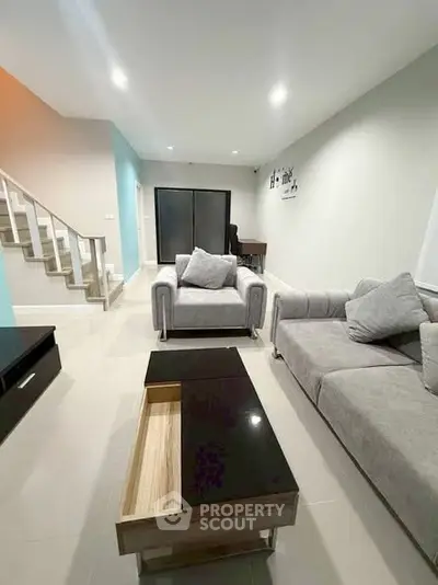 Modern living room with stylish gray sofas and sleek coffee table