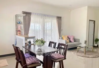 Charming open-plan living and dining area with cozy decor and natural light.