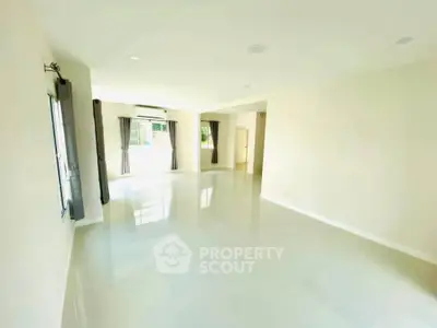 Spacious and bright living room with large windows and modern design.