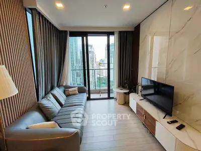 Modern living room with city view, stylish sofa, and large TV setup.