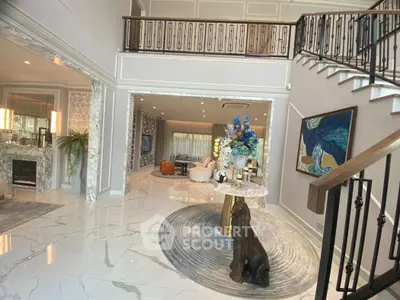 Luxurious open-concept living room with elegant decor and high ceilings