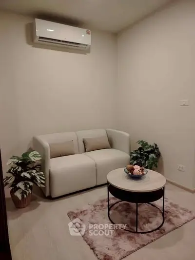 Cozy living room with modern sofa, air conditioning, and stylish decor