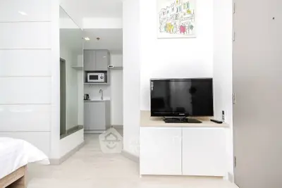 Modern studio apartment with sleek kitchen and cozy living area