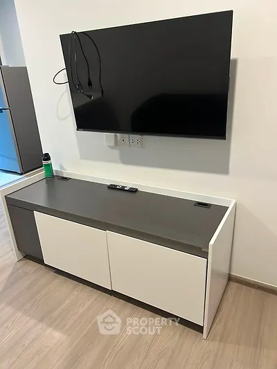 Modern living room with wall-mounted TV and sleek storage unit, perfect for contemporary homes.