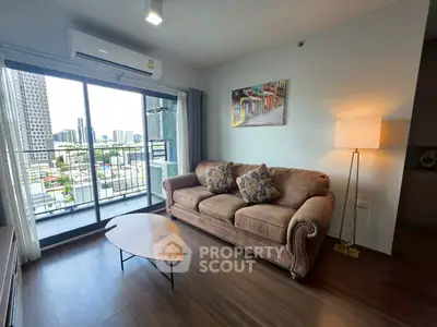 Chic urban living room with cozy sofa and city view balcony in modern apartment.