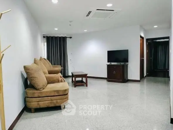 Spacious living room with modern decor and comfortable seating in a stylish apartment.