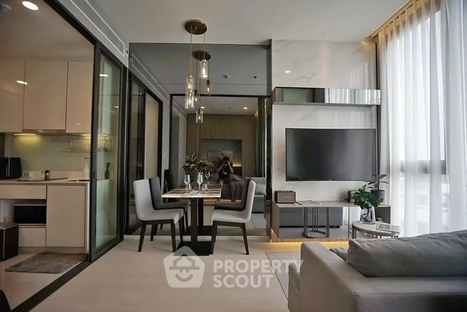 Modern open-plan living room with dining area and sleek kitchen in luxury apartment