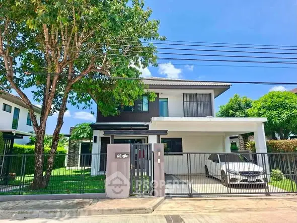Modern two-story house with carport and lush greenery in a serene neighborhood.