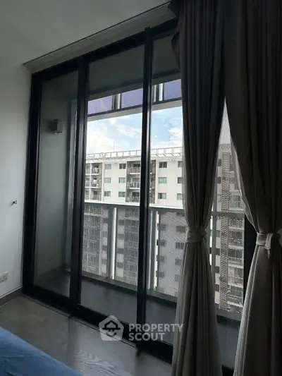 Modern apartment with floor-to-ceiling windows and city view balcony