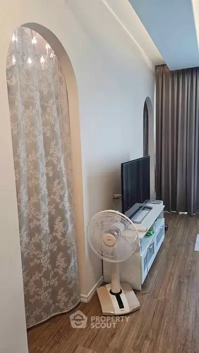 Stylish living room with modern TV setup and elegant curtain design