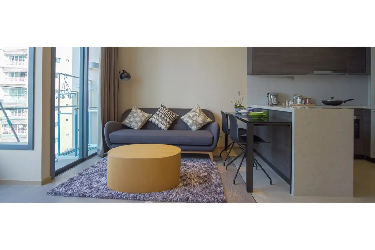 Modern open-plan living room with stylish decor and balcony view