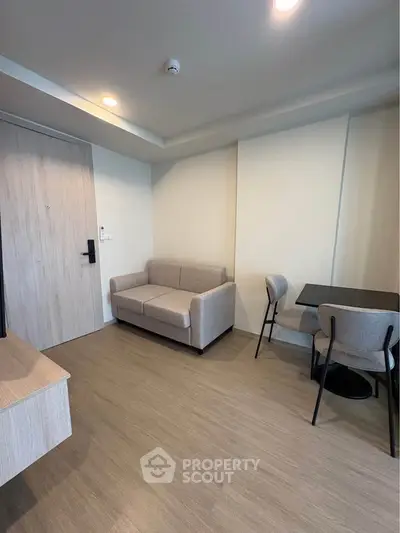 Modern living room with cozy sofa and dining area in stylish apartment