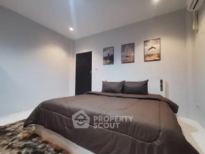 Modern bedroom with stylish decor and cozy bedding in a contemporary home.