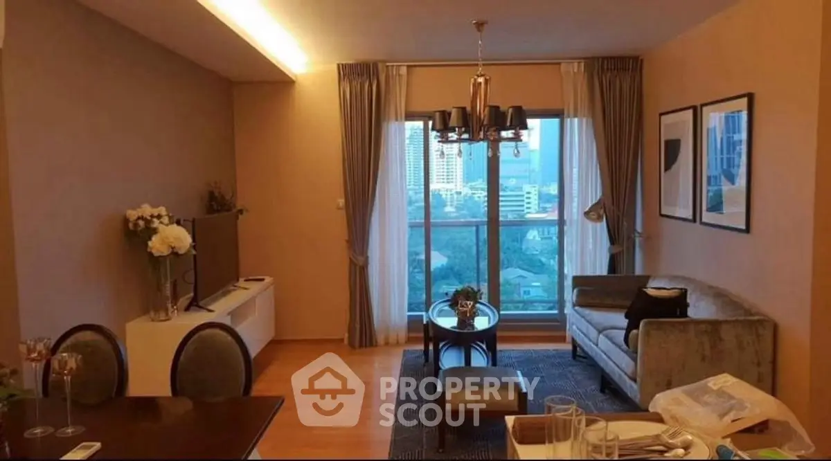 Elegant living room with city view, modern decor, and cozy seating area.