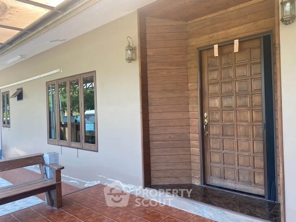 Charming wooden entrance with tiled patio and rustic bench