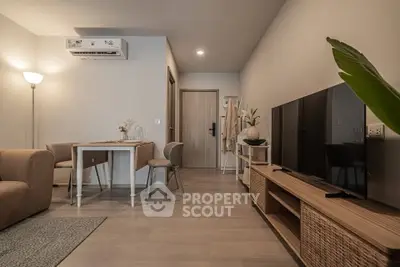 Modern living room with stylish furniture and large TV, perfect for relaxation.