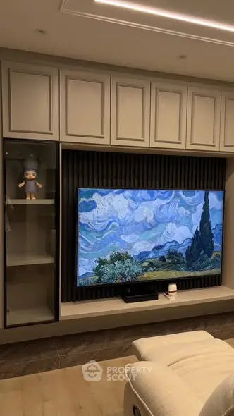 Modern living room with stylish TV setup and elegant cabinetry