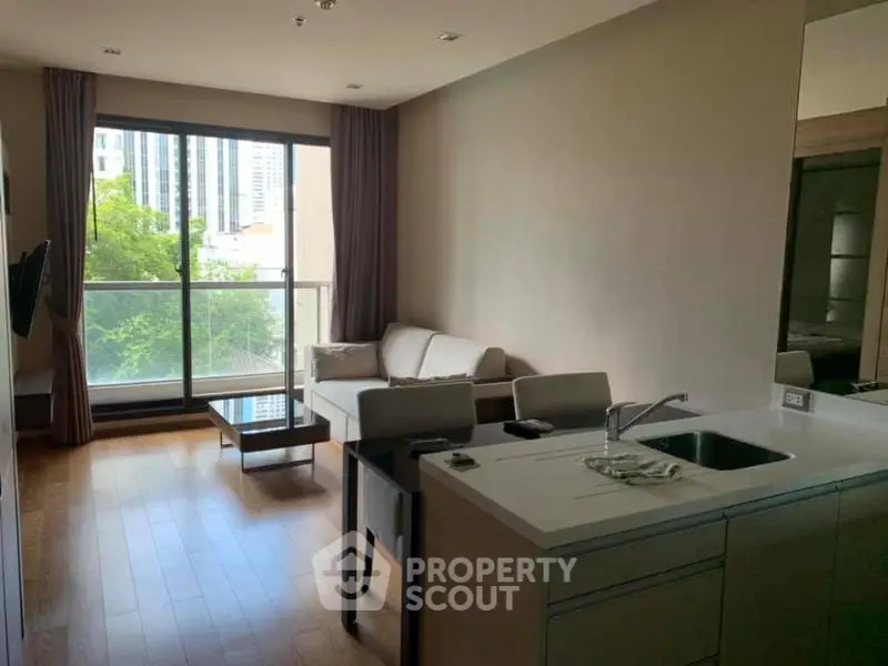 Modern living room with open kitchen and large window view