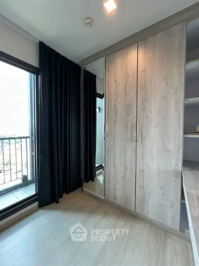 Modern bedroom with balcony access and sleek wardrobe design
