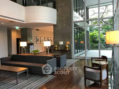 Luxurious modern living room with large windows and elegant furniture