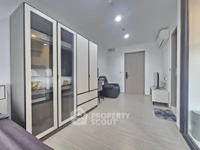 Modern living room with sleek furniture and ample storage in a contemporary apartment.